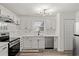Modern kitchen with white cabinets and stainless steel appliances at 4251 Villas Dr. # 303, Little River, SC 29566