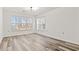 Living room with two windows and wood-look floors at 4251 Villas Dr. # 303, Little River, SC 29566