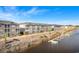 Exterior view of waterfront condo featuring screened balconies and private boat docks along the canal at 4518 N Plantation Harbour Dr. # G-1, Little River, SC 29566