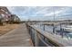 Wooden boardwalk path with marina and building views at 4617 Lightkeepers Way # 9-I, Little River, SC 29566