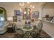 Dining area with glass table, metal chairs, and gallery wall at 4617 Lightkeepers Way # 9-I, Little River, SC 29566