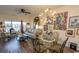 Living room with dining area, hardwood floors, and water views at 4617 Lightkeepers Way # 9-I, Little River, SC 29566