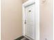 White front door with brass hardware and number 202 at 4773 Wild Iris Dr. # 5-202, Myrtle Beach, SC 29577