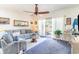 Living room with gray sofa, glass coffee table, and access to balcony at 4773 Wild Iris Dr. # 5-202, Myrtle Beach, SC 29577