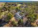 Scenic aerial view of a home nestled in trees near a golf course, with water in the distance at 489-3 Golden Bear Dr. # 3, Pawleys Island, SC 29585
