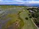 Stunning aerial view of the neighborhood featuring water views, golf, and marsh at 489-3 Golden Bear Dr. # 3, Pawleys Island, SC 29585