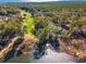 Aerial view showcasing a lush golf course, lake, and waterfront home at 489-3 Golden Bear Dr. # 3, Pawleys Island, SC 29585