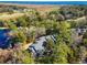Breathtaking aerial view of a house surrounded by lush trees, a golf course, and water at 489-3 Golden Bear Dr. # 3, Pawleys Island, SC 29585