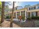 Brick home featuring an outdoor patio with a wooden bench and lots of potted plants at 489-3 Golden Bear Dr. # 3, Pawleys Island, SC 29585