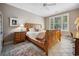 Bedroom with wood sleigh bed, ceiling fan, and a window with plantation shutters at 489-3 Golden Bear Dr. # 3, Pawleys Island, SC 29585
