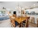 Open-concept dining room with a wooden table, seating for six, and a view into the living room and kitchen at 489-3 Golden Bear Dr. # 3, Pawleys Island, SC 29585