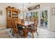 Bright dining area with wooden table and chairs, complemented by a china cabinet and sliding doors to a screened porch at 489-3 Golden Bear Dr. # 3, Pawleys Island, SC 29585
