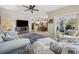 Spacious living room with comfortable seating, ceiling fan, access to the screened-in porch, and view into the kitchen at 489-3 Golden Bear Dr. # 3, Pawleys Island, SC 29585