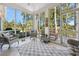 Bright sunroom with tile floors and multiple windows overlooking the backyard and golf course at 489-3 Golden Bear Dr. # 3, Pawleys Island, SC 29585