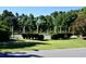 Well-maintained tennis courts surrounded by manicured hedges and tall trees at 489-3 Golden Bear Dr. # 3, Pawleys Island, SC 29585
