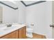 Small half bathroom with wood vanity and white toilet at 502 Hay Hill Ln. # B, Myrtle Beach, SC 29579