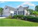 White two-story house with gray shutters, a white picket fence, and a well-manicured lawn at 5508 Whistling Duck Dr., North Myrtle Beach, SC 29582