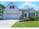Two-story house with attached garage, landscaped yard, and white exterior at 5508 Whistling Duck Dr., North Myrtle Beach, SC 29582