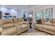 Relaxing living room with two leather recliners, a view into the kitchen, and a sliding glass door at 5508 Whistling Duck Dr., North Myrtle Beach, SC 29582