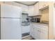 Small kitchen with white cabinets and appliances at 5905 South Kings Hwy. # 408, Myrtle Beach, SC 29575