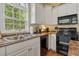 Bright kitchen with white cabinets, black appliances, and granite countertops at 6001 - 1243 S Kings Hwy., Myrtle Beach, SC 29575