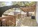 Spacious deck with pergola, seating area, and large shade tree at 6001-Mh53 S Kings Highway, Myrtle Beach, SC 29575