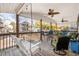 Covered deck with ceiling fan, comfortable seating, and porch swing at 6001-Mh53 S Kings Highway, Myrtle Beach, SC 29575