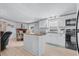 Modern kitchen with white cabinets, kitchen island, and black appliances at 6001-Mh53 S Kings Highway, Myrtle Beach, SC 29575