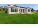 Newly built home with beige siding, black shutters, and a spacious lawn at 621 Bay St., Aynor, SC 29511