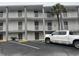 Multi-story building exterior with balconies and parking at 6803 N Ocean Blvd. # 115, Myrtle Beach, SC 29572
