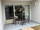 Small patio with two chairs and a table, overlooking a pool at 6803 N Ocean Blvd. # 115, Myrtle Beach, SC 29572