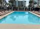 Large rectangular pool with plenty of lounge chairs at 6803 N Ocean Blvd. # 115, Myrtle Beach, SC 29572