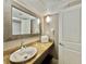 Well-lit bathroom featuring a granite countertop, vessel sink, and decorative framed mirror at 6900 N Ocean Blvd. # 1234, Myrtle Beach, SC 29577