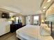 Bright and airy bedroom with a dresser and a view of the outside at 6900 N Ocean Blvd. # 1234, Myrtle Beach, SC 29577