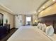 Cozy bedroom with wood-look floors and a view of the outside at 6900 N Ocean Blvd. # 1234, Myrtle Beach, SC 29577