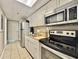 A modern kitchen featuring stainless steel appliances and granite countertops at 6900 N Ocean Blvd. # 1234, Myrtle Beach, SC 29577