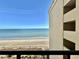 Balcony view showcasing the beach, clear skies, and ocean from an elevated vantage point at 6900 N Ocean Blvd. # 1234, Myrtle Beach, SC 29577