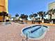 Outdoor resort pools with a jacuzzi, blue tile, brick pavers, and swaying palm trees offering a relaxing atmosphere at 6900 N Ocean Blvd. # 1234, Myrtle Beach, SC 29577