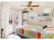 Bright bedroom with a multicolored bedspread and French doors leading outside at 727 Cypress Dr., Surfside Beach, SC 29575