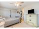 Spacious bedroom with a dresser, ceiling fan, and large closet at 775 Plantation Dr. # 48, Little River, SC 29566