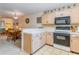 Open kitchen with island, dining area view, and white countertops at 775 Plantation Dr. # 48, Little River, SC 29566