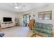Living area with TV, sofa, and access to patio at 775 Plantation Dr. # 48, Little River, SC 29566