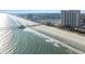 Aerial shot of the coastline, showcasing the beach and high-rise building at 8500 Margate Circle # 606, Myrtle Beach, SC 29572