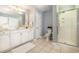 Clean bathroom with shower, double vanity, and white cabinets at 8500 Margate Circle # 606, Myrtle Beach, SC 29572