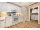 White kitchen features ample cabinetry, an electric range, and microwave at 8500 Margate Circle # 606, Myrtle Beach, SC 29572
