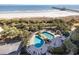 Aerial view of resort-style pool with surrounding lounge chairs at 8500 Margate Circle # 606, Myrtle Beach, SC 29572