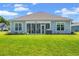 Beautiful backyard view showcasing a well-maintained lawn, patio and fresh landscaping at 10 Grace Bay Ct., Pawleys Island, SC 29585