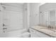 A bright bathroom features a shower-tub combination and granite countertop vanity at 10 Grace Bay Ct., Pawleys Island, SC 29585