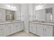 Bathroom featuring double sinks, granite countertops, mirrors, and modern lighting at 10 Grace Bay Ct., Pawleys Island, SC 29585