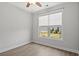 Bright, airy bedroom with large window overlooking backyard and wood-look floors at 10 Grace Bay Ct., Pawleys Island, SC 29585